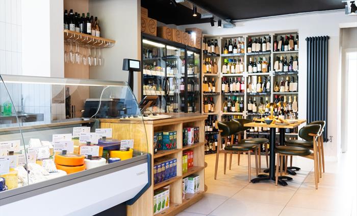 Cheese and wine counter display at a deli